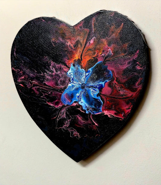 Handmade heart-shaped canvas with an abstract blue flower amid red and black accents.